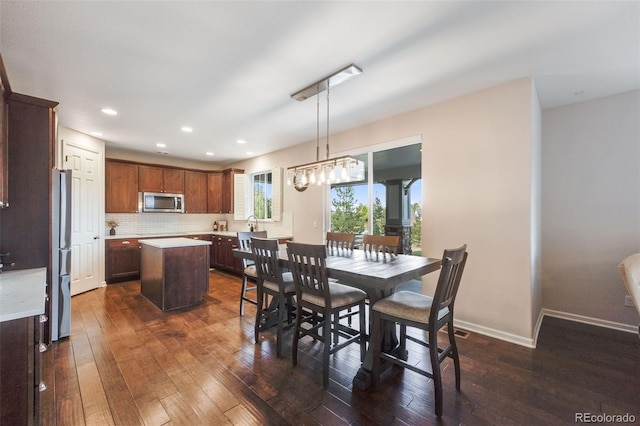 dining space with dark hardwood / wood-style floors