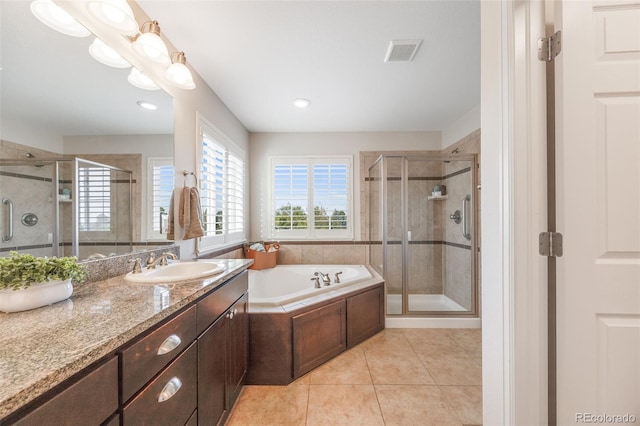 bathroom with tile patterned flooring, vanity, and shower with separate bathtub