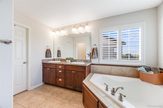 bathroom with tiled bath, tile patterned flooring, a wealth of natural light, and vanity