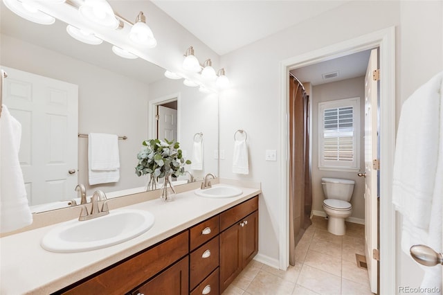 bathroom featuring tile patterned floors, vanity, and toilet