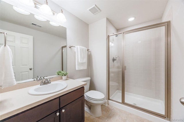 bathroom featuring toilet, a shower with door, and vanity