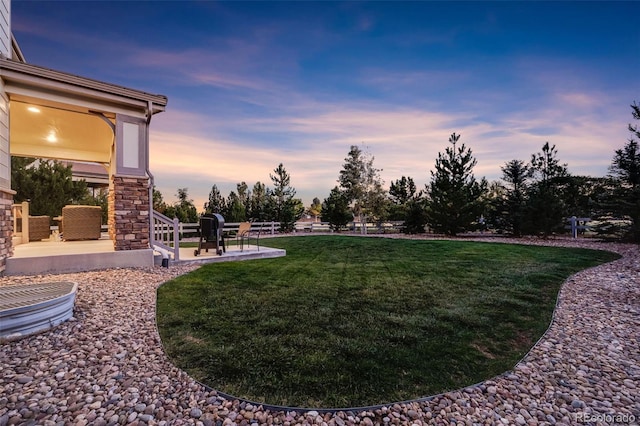 yard at dusk with a patio