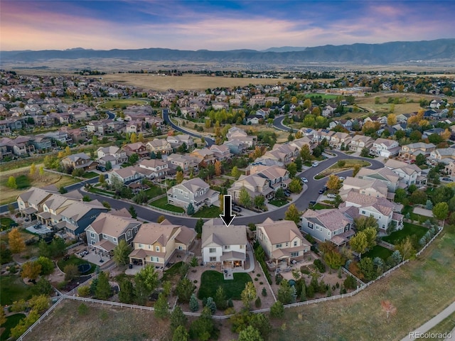 aerial view at dusk featuring a mountain view