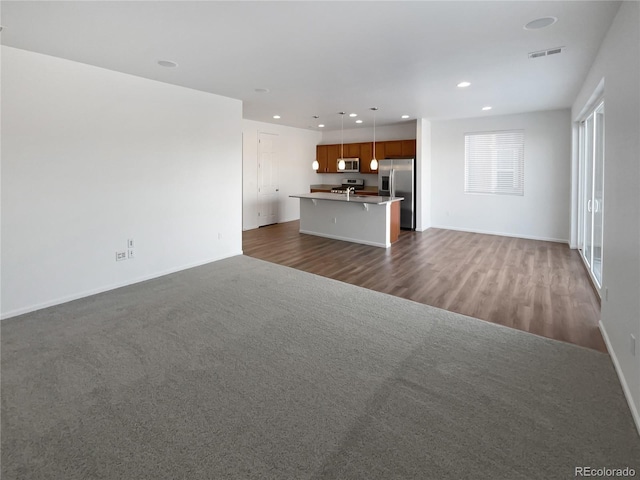 unfurnished living room featuring dark hardwood / wood-style floors