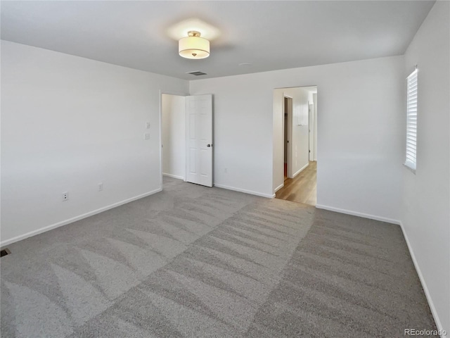 unfurnished room with light colored carpet