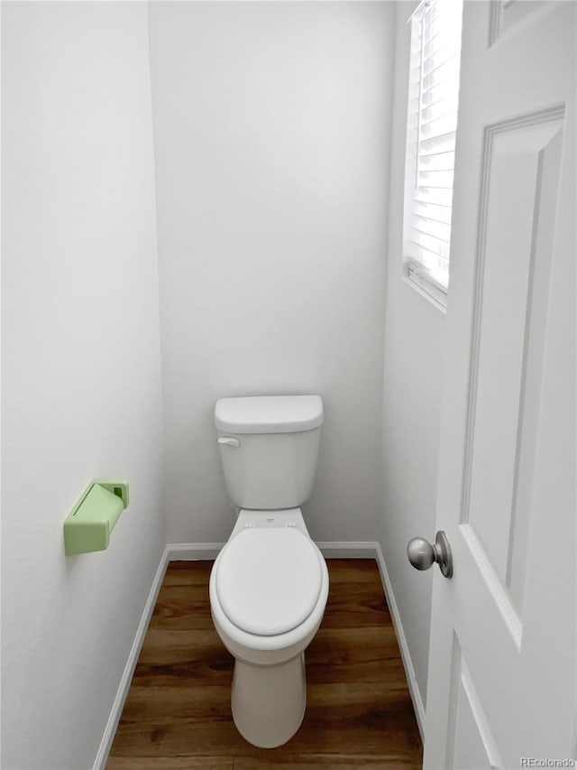 bathroom with toilet and wood-type flooring