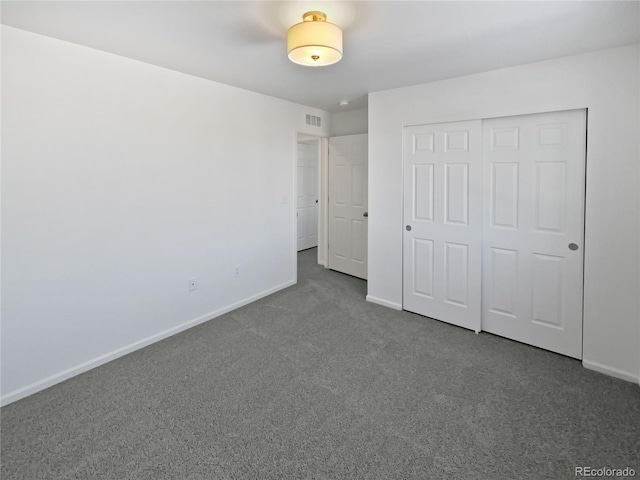 unfurnished bedroom featuring a closet and carpet