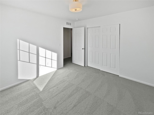 unfurnished bedroom with a closet and carpet flooring