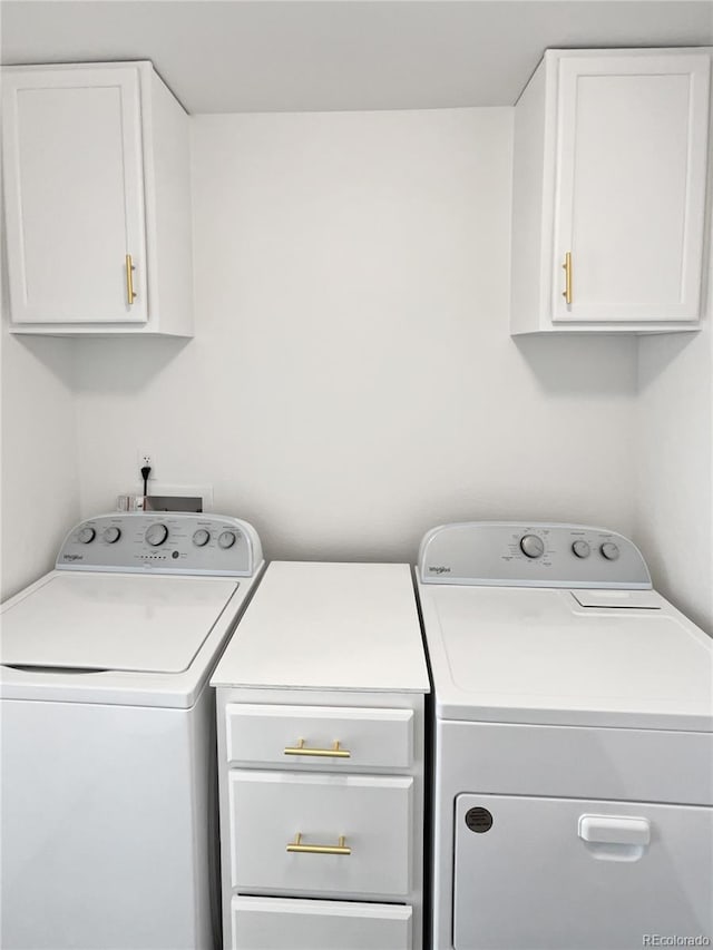 laundry room with cabinets and separate washer and dryer