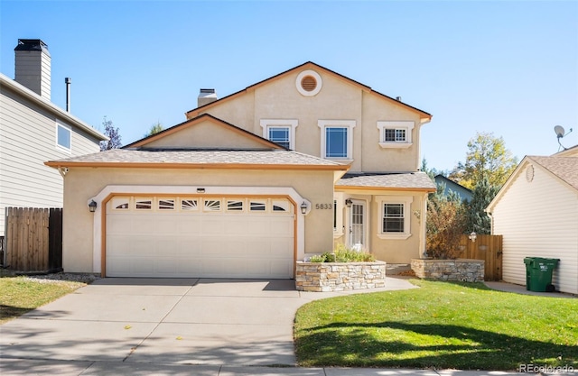 front facade with a front yard and a garage