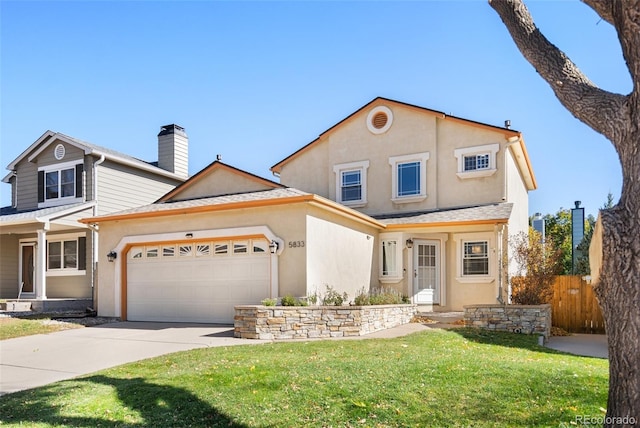 front facade featuring a front lawn and a garage