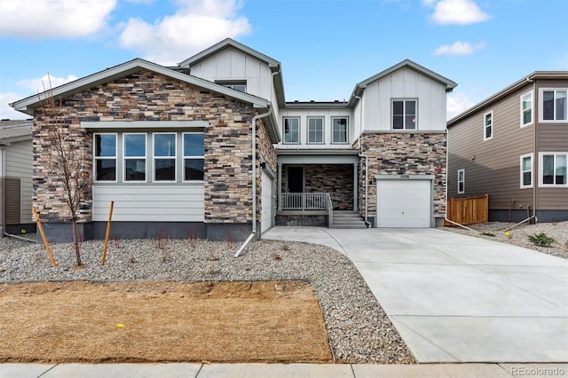 view of front of home featuring stone siding, covered porch, board and batten siding, concrete driveway, and a garage