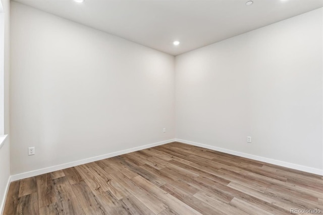 unfurnished room featuring light wood-style flooring, recessed lighting, and baseboards