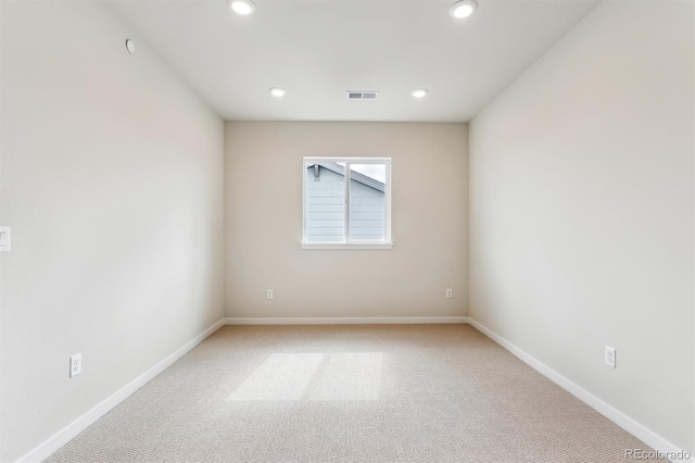 unfurnished room with recessed lighting, visible vents, baseboards, and light colored carpet