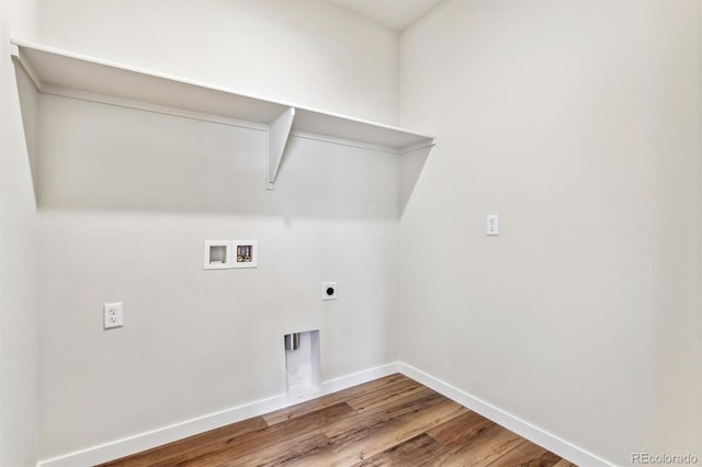 laundry area featuring electric dryer hookup, washer hookup, wood finished floors, baseboards, and laundry area