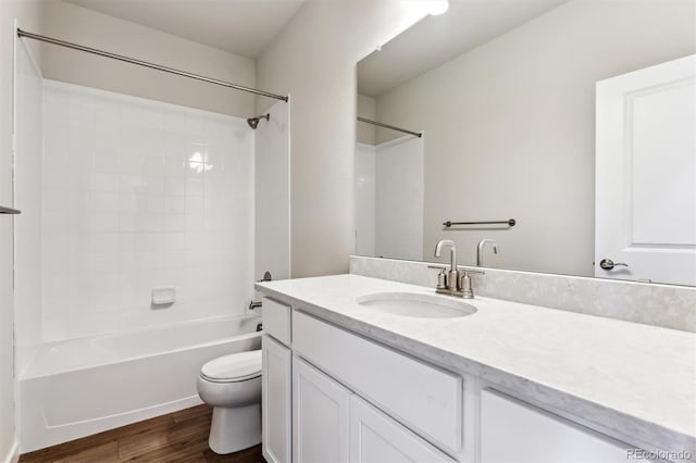 full bath featuring shower / bath combination, toilet, vanity, and wood finished floors