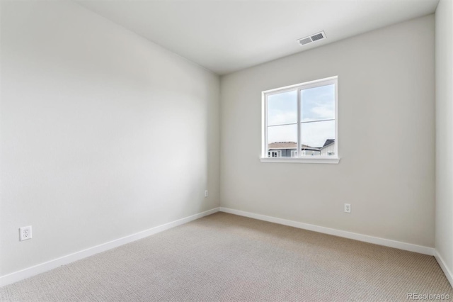 carpeted empty room with baseboards and visible vents