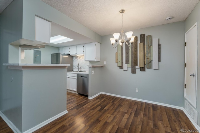 kitchen featuring backsplash, white cabinets, sink, appliances with stainless steel finishes, and a notable chandelier