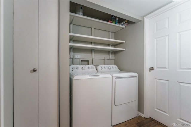 laundry area featuring dark wood-type flooring and washing machine and clothes dryer