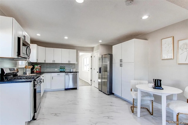 784 S 3rd Ave, Brighton, CO 80601 - kitchen featuring stainless steel appliances, light marble finish flooring, dark countertops, white cabinets, and recessed lighting