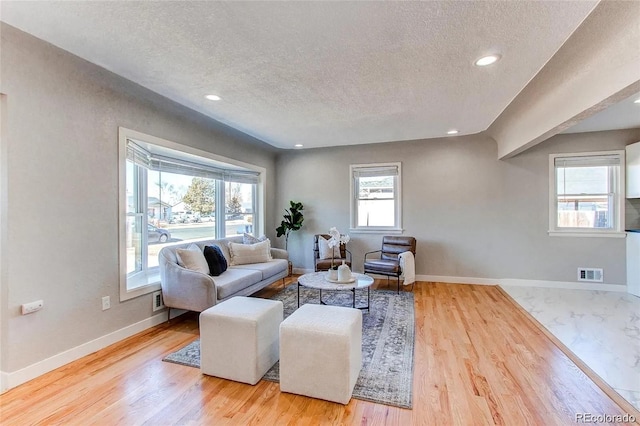 784 S 3rd Ave, Brighton, CO 80601 - living area with a textured ceiling, baseboards, wood finished floors, and recessed lighting