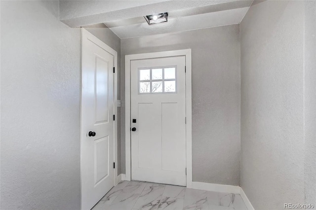 784 S 3rd Ave, Brighton, CO 80601 - entryway featuring baseboards, a textured wall, and light marble finish flooring