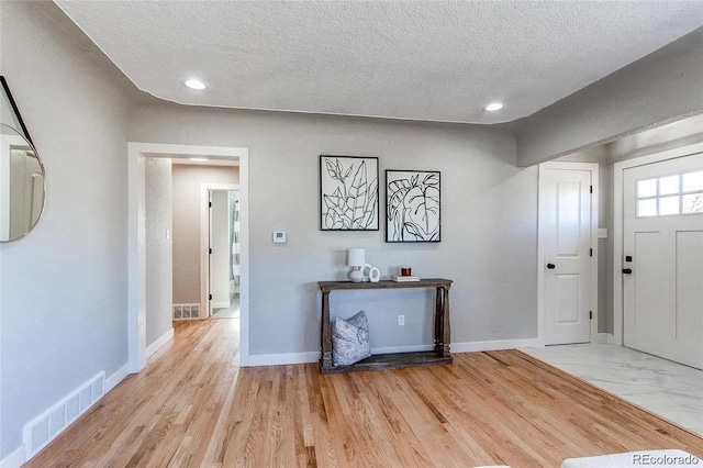 784 S 3rd Ave, Brighton, CO 80601 - foyer entrance with a textured ceiling, recessed lighting, baseboards, and light wood-type flooring