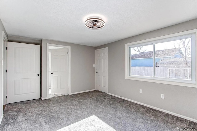 784 S 3rd Ave, Brighton, CO 80601 - carpeted entryway with baseboards and a textured ceiling