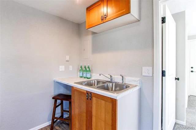 784 S 3rd Ave, Brighton, CO 80601 - bar featuring a sink and baseboards