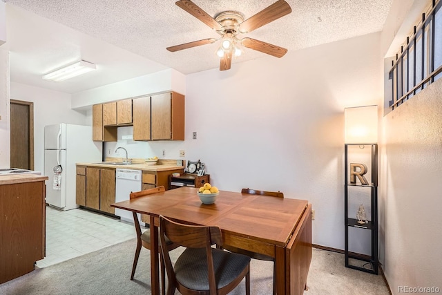 carpeted dining room featuring ceiling fan, sink, and a textured ceiling