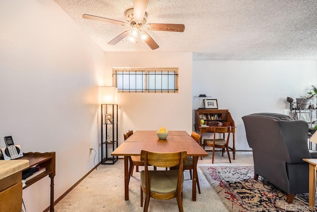 carpeted dining space with ceiling fan and a textured ceiling