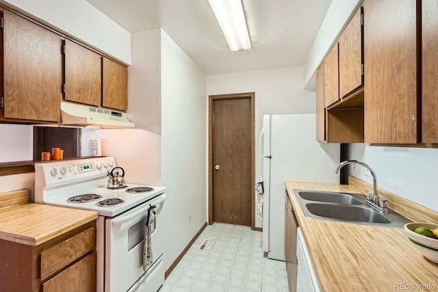 kitchen with sink and white appliances