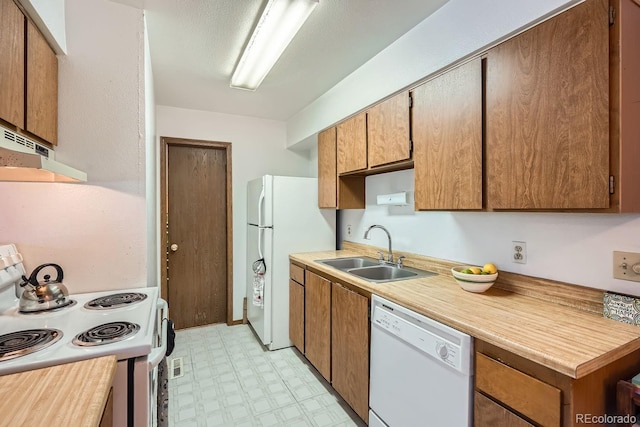 kitchen with sink and white appliances