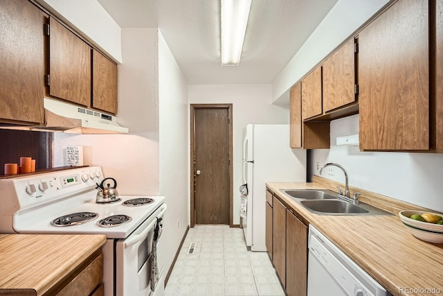 kitchen with white appliances and sink