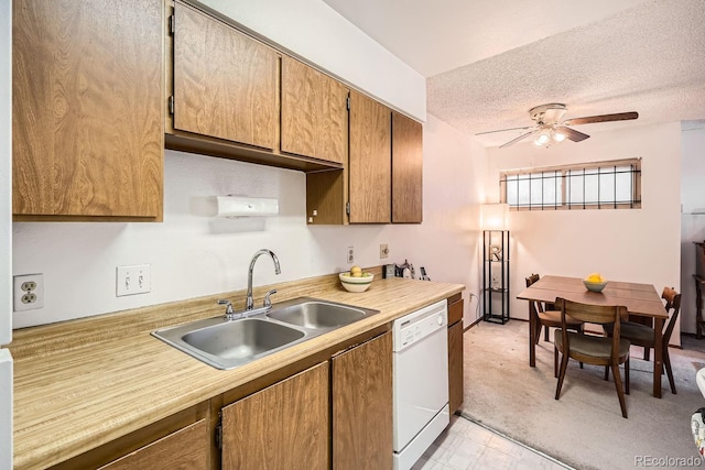 kitchen featuring ceiling fan, sink, a textured ceiling, and white dishwasher