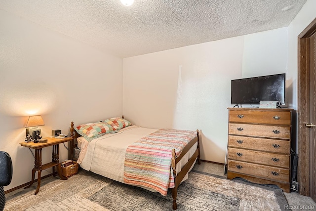 bedroom featuring carpet floors and a textured ceiling