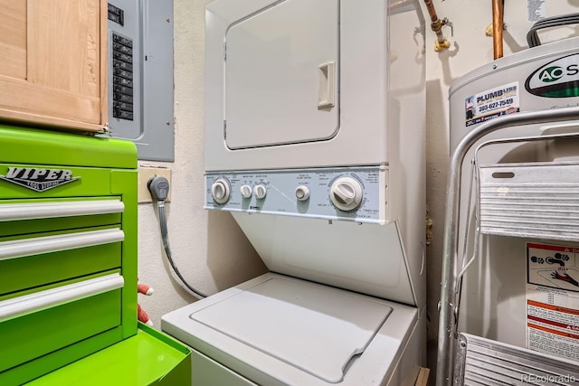 washroom featuring electric panel and stacked washer and clothes dryer