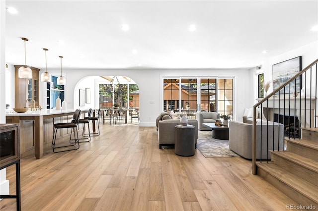 living room featuring plenty of natural light and light hardwood / wood-style flooring