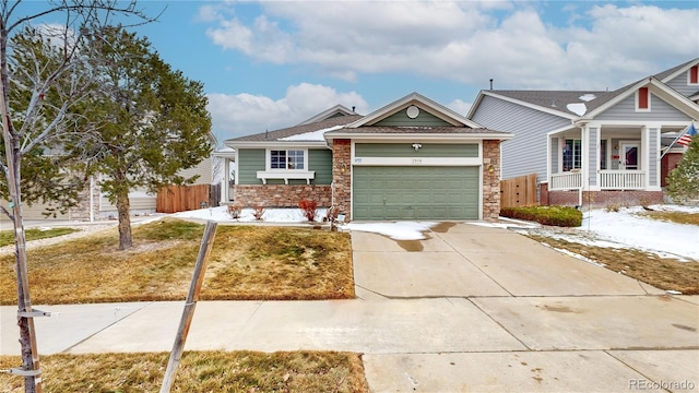 view of front of property with covered porch, concrete driveway, stone siding, and an attached garage