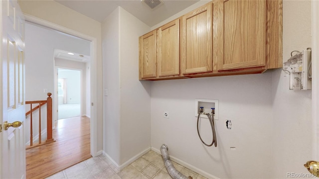 clothes washing area with hookup for a washing machine, visible vents, baseboards, cabinet space, and electric dryer hookup