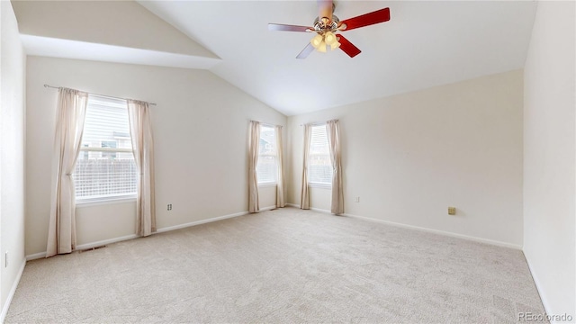 unfurnished room featuring carpet floors, ceiling fan, baseboards, and vaulted ceiling