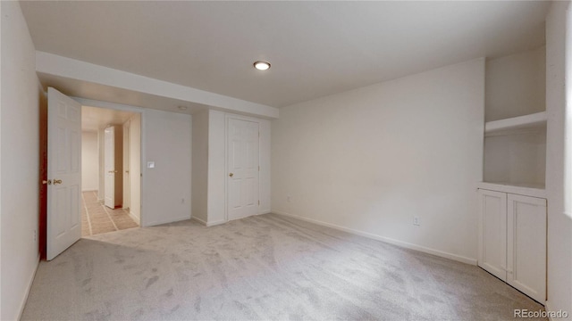 unfurnished bedroom featuring carpet and baseboards