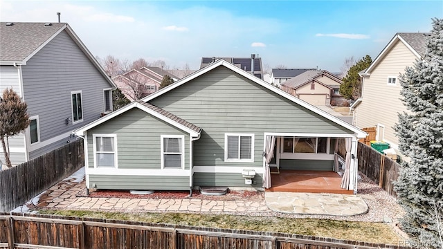 back of house featuring a fenced backyard and a patio