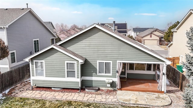 back of property featuring a patio area and a fenced backyard