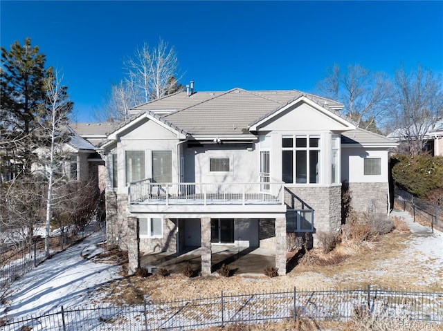 view of snow covered rear of property