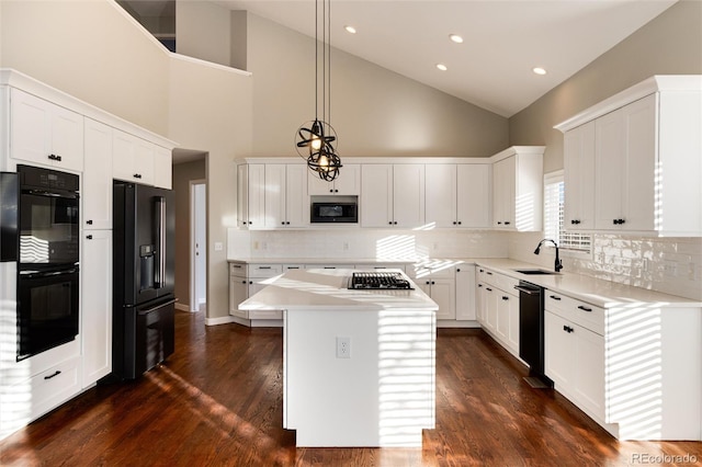 kitchen with white cabinetry, a center island, high vaulted ceiling, pendant lighting, and black appliances