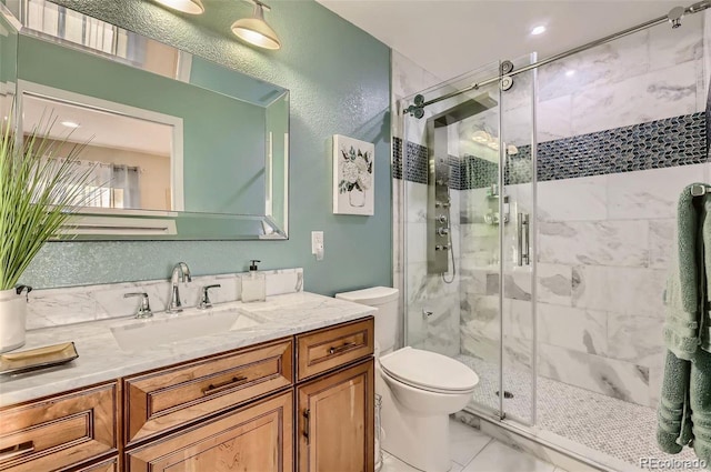 bathroom with walk in shower, vanity, and toilet