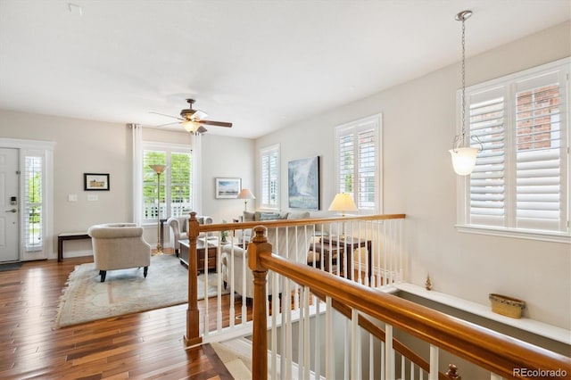 2723 Galena St, Denver, CO 80238 - corridor with plenty of natural light, wood finished floors, and an upstairs landing
