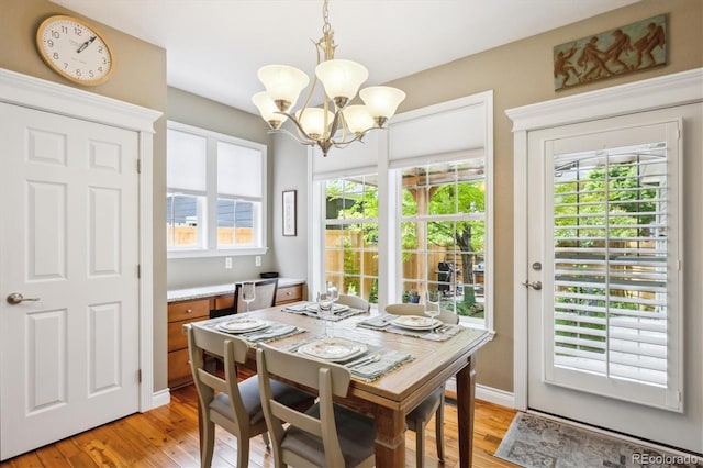 2723 Galena St, Denver, CO 80238 - dining room with a chandelier, light wood finished floors, and healthy amount of natural light