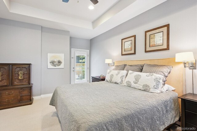 2723 Galena St, Denver, CO 80238 - bedroom featuring light carpet, a raised ceiling, a ceiling fan, access to exterior, and baseboards